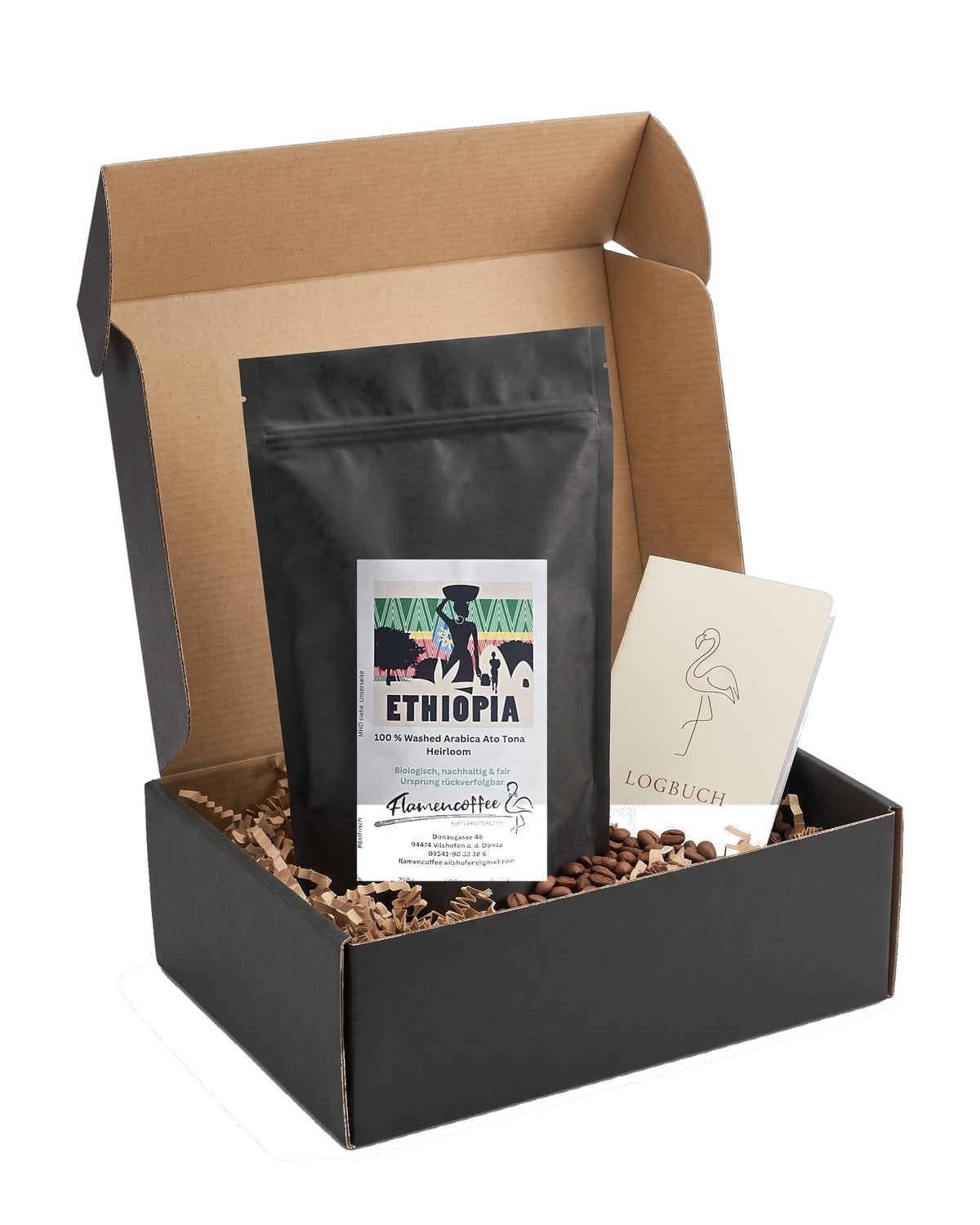 Flamencoffee Club Box – offene Box mit Kaffeetüte des Monats und Logbuch auf Weiß